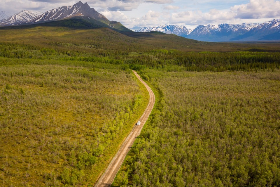Arial view of a car on the McCarthy Road surrounded by greenery