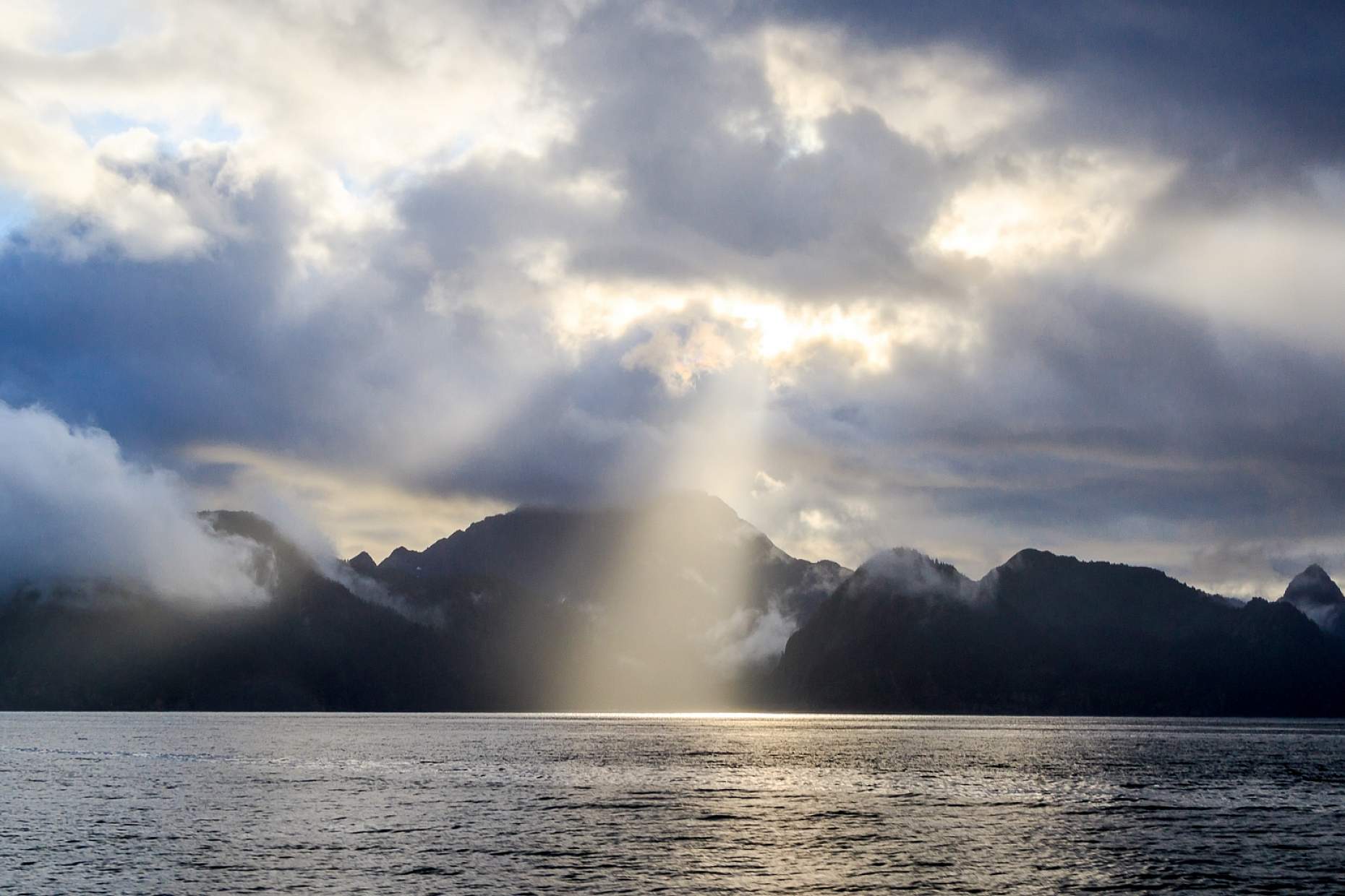 Sun peaks through the clouds in Kenai Fjords National Park