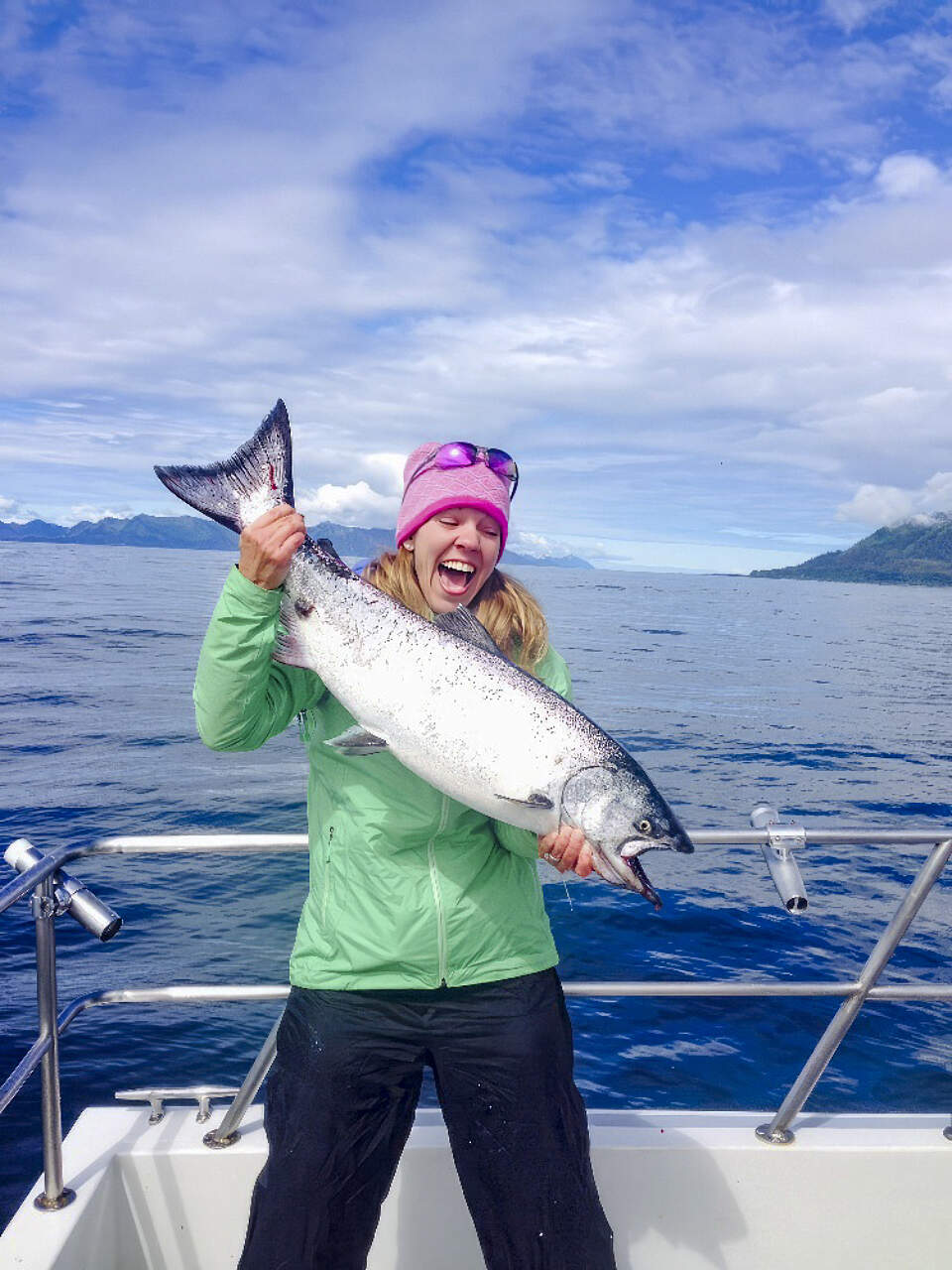 Happy woman with her catch of Salmon on a fishing charter with ProFish-N-Sea in Seward Alaska