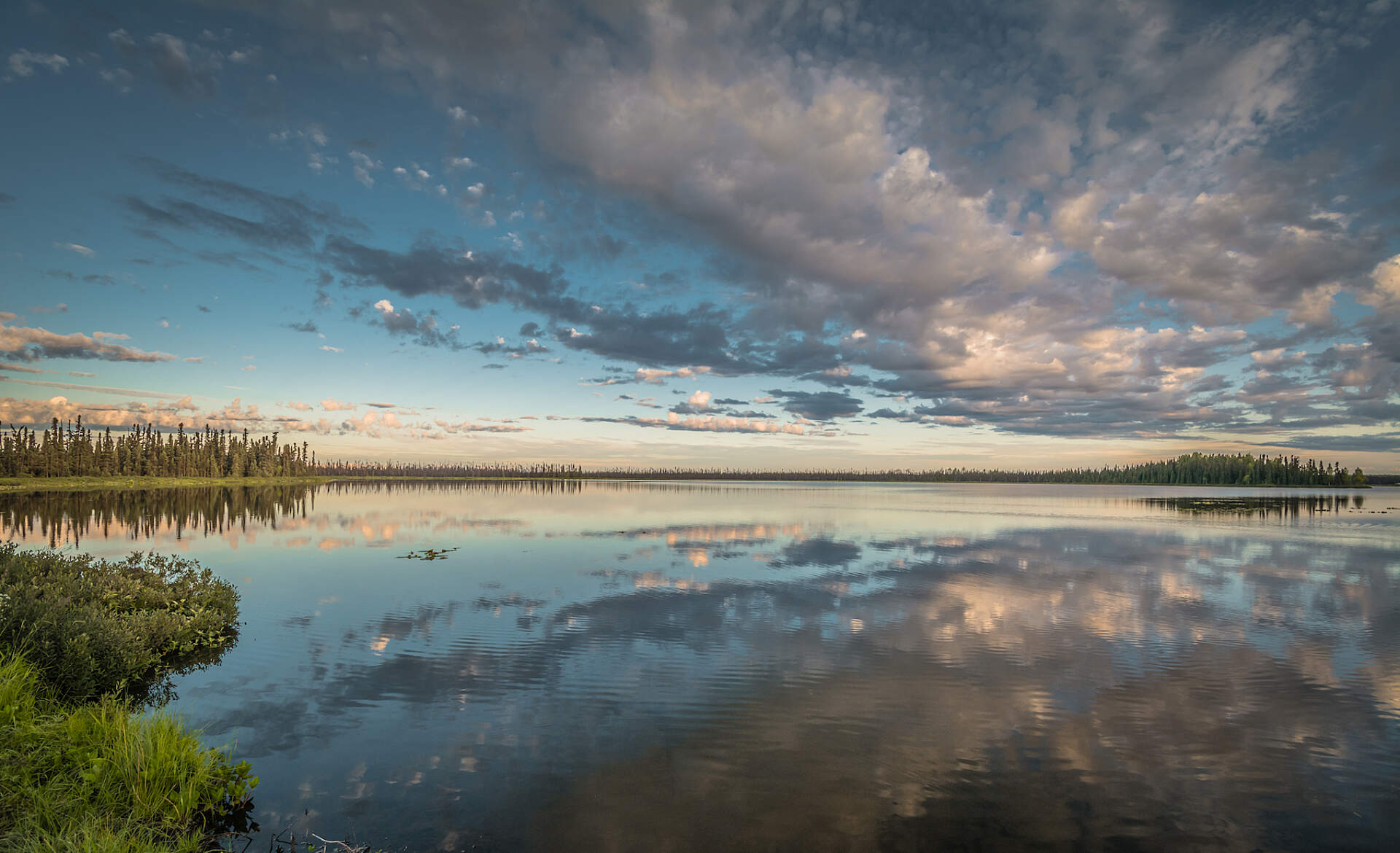 A sky reflects onto a lake in Alaska.