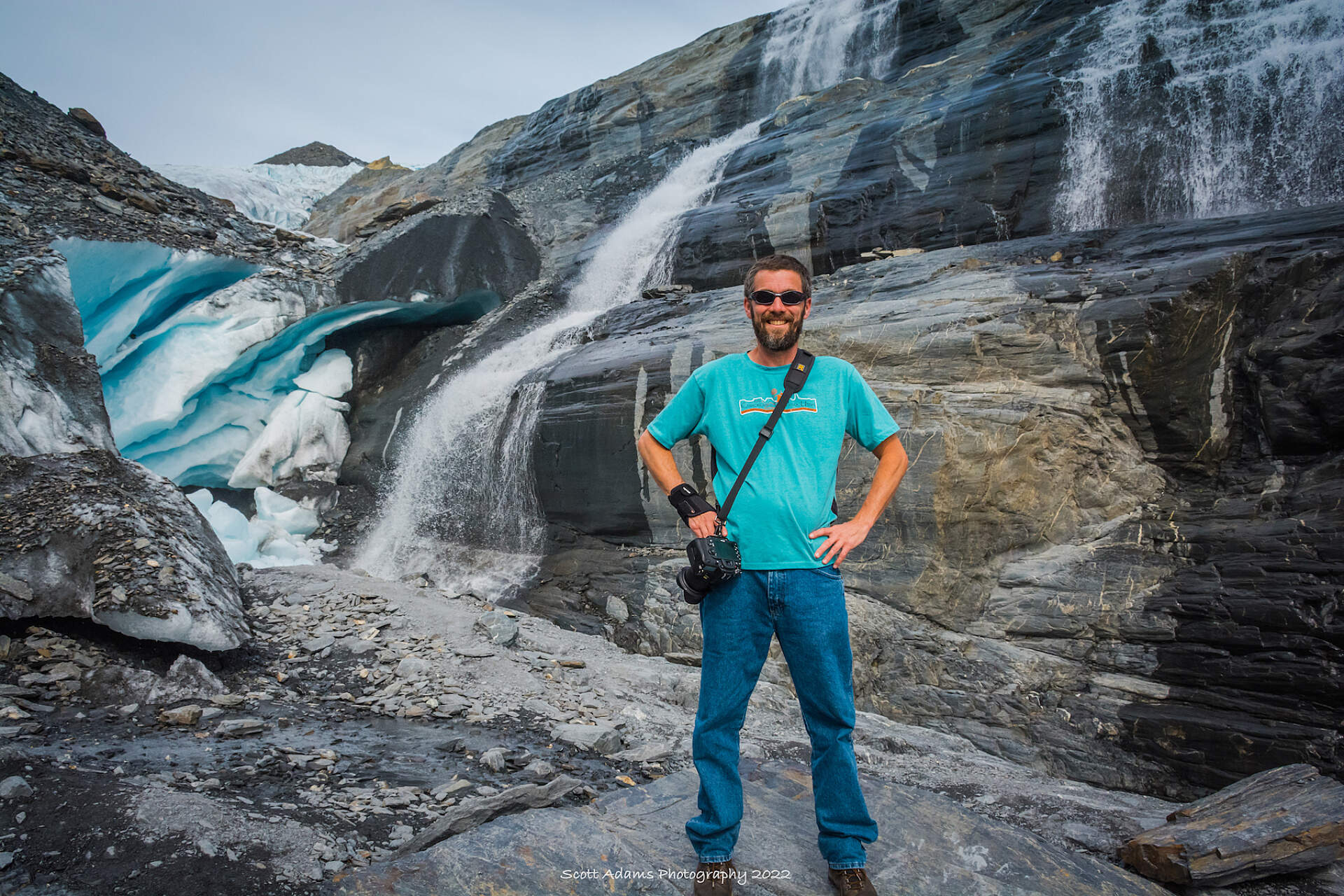 Scott Adams standing infront of a glacier in Alaska.