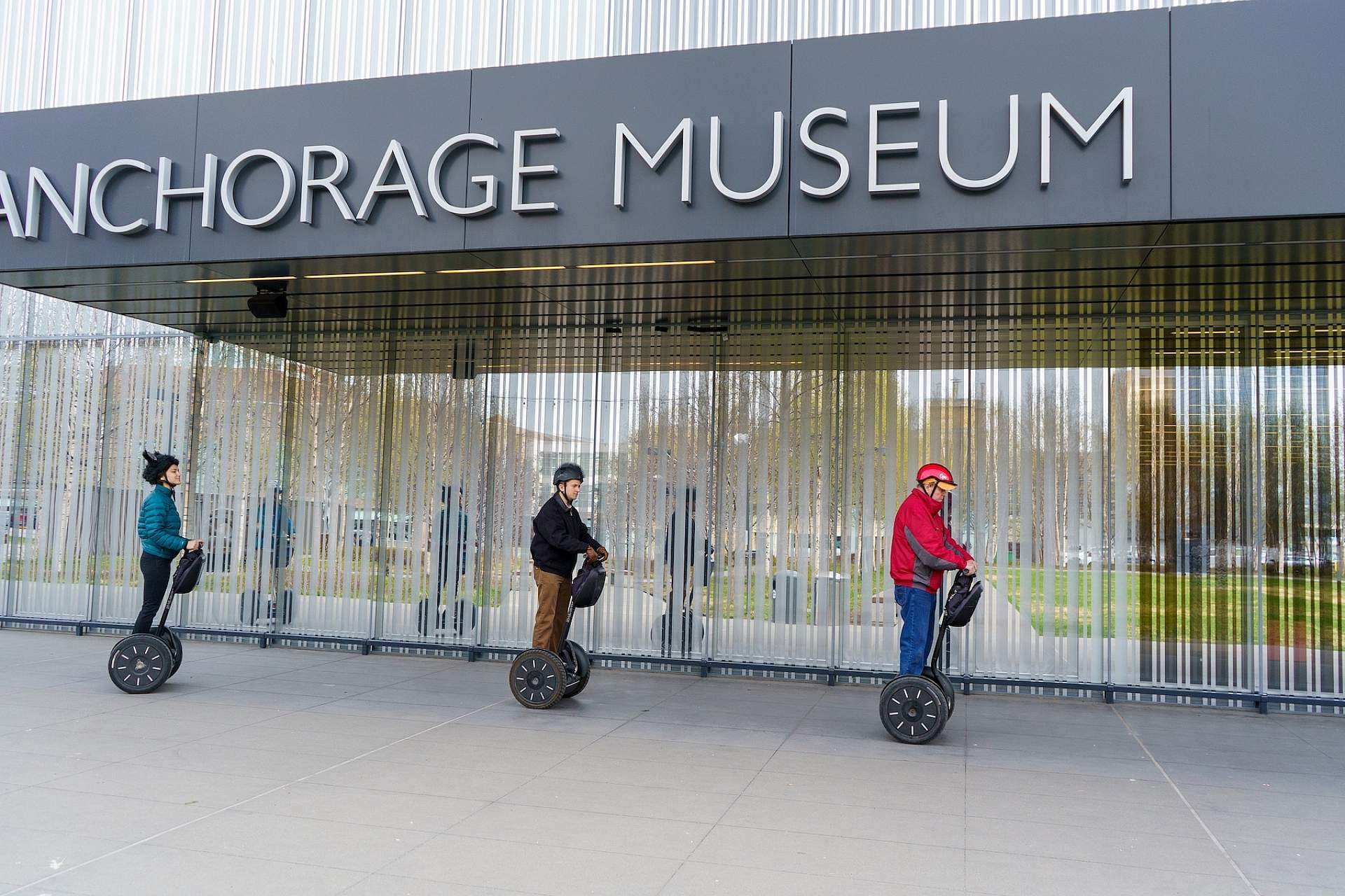 A tour group of Segways rides past the Anchorage Museum in Anchorage, Alaska.