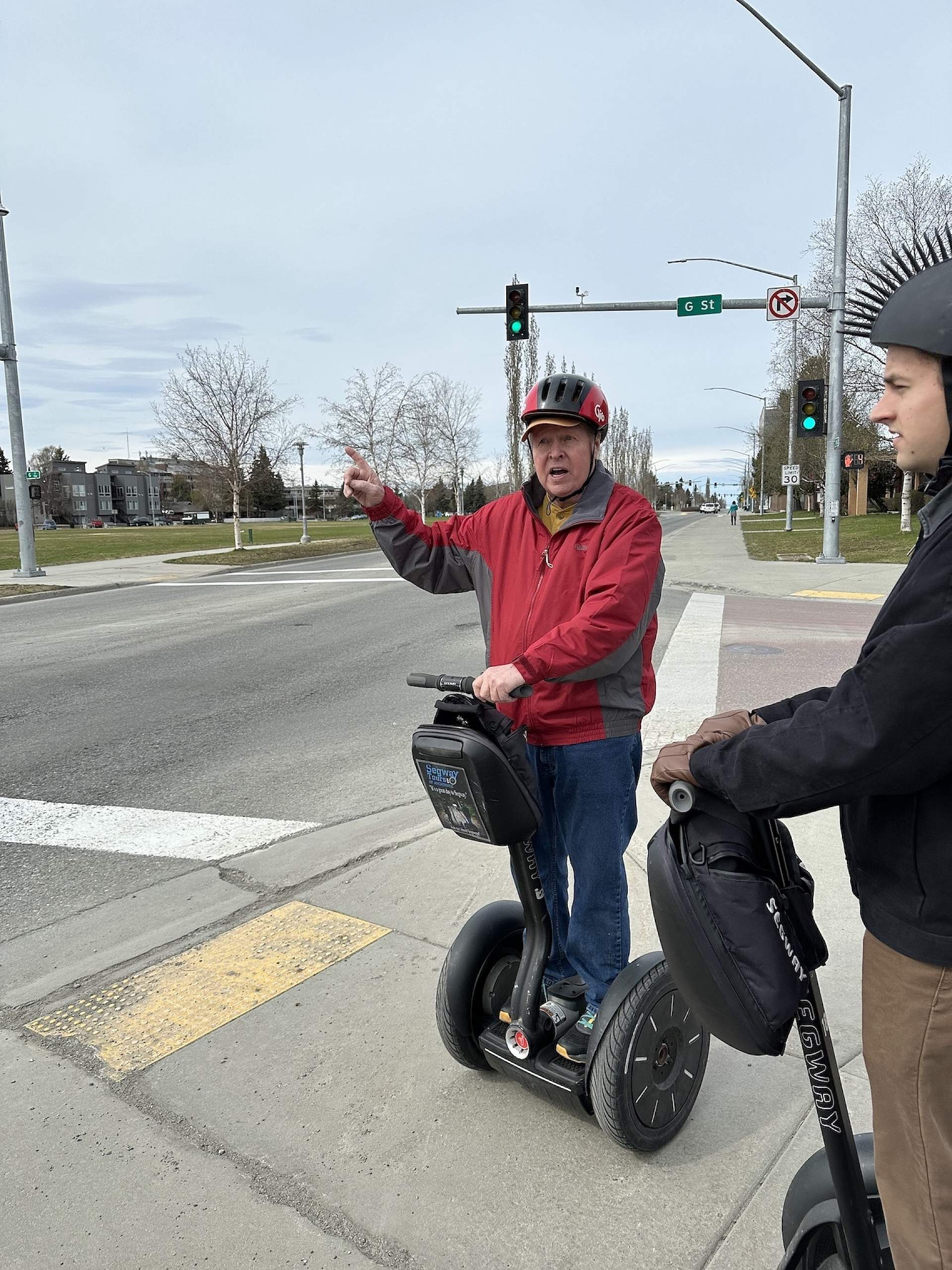 A group on a Segway tour waits at a busy street corner in Anchorage, Alaska.