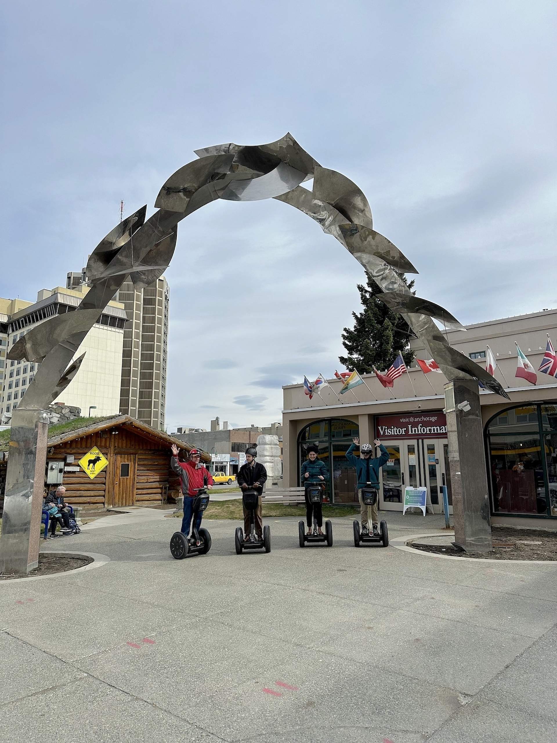 A group of Segways poses for a photo under the metal arch in Anchorage, Alaska.