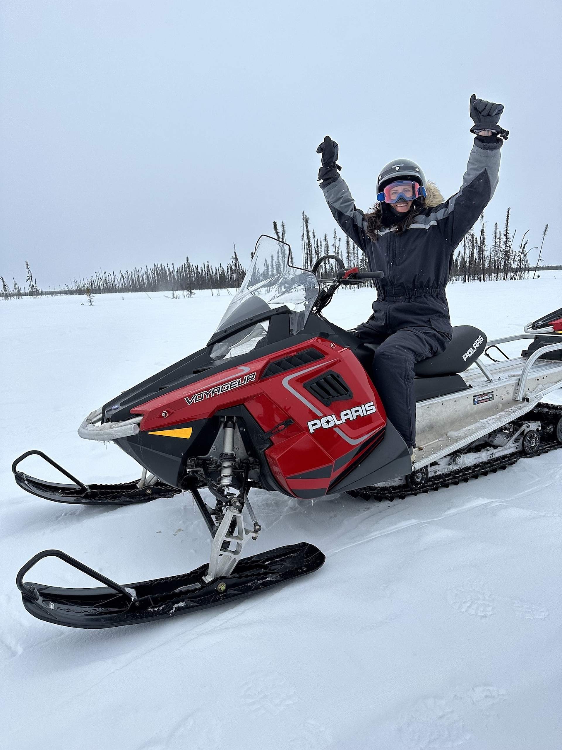 Jaime rides a snowmachine on a tour at Snowhook Adventure Guides of Alaska.