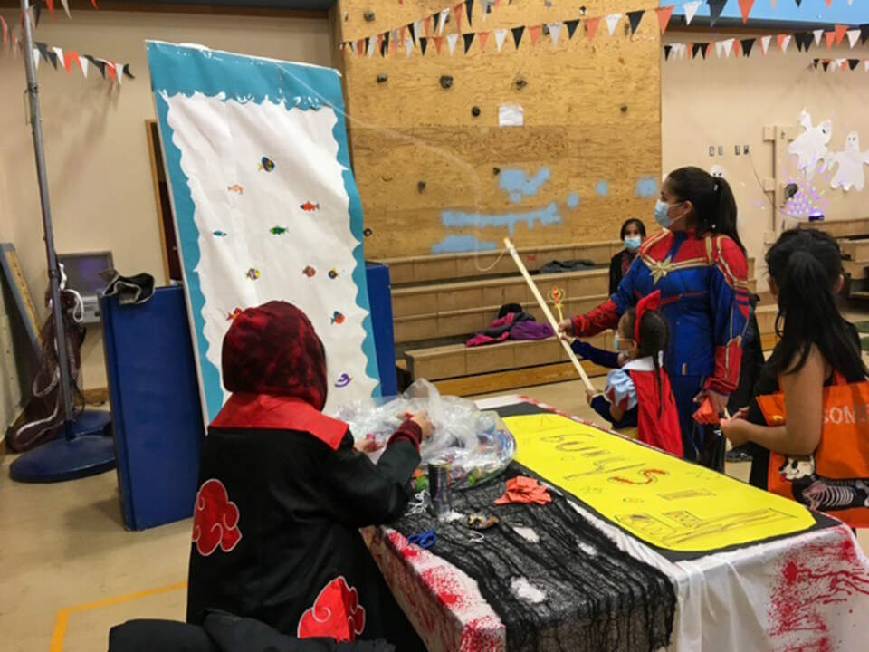 Inside the school gym: costumes, carnival games, and the Bubble Gum Challenge that made me part of the town for a night.