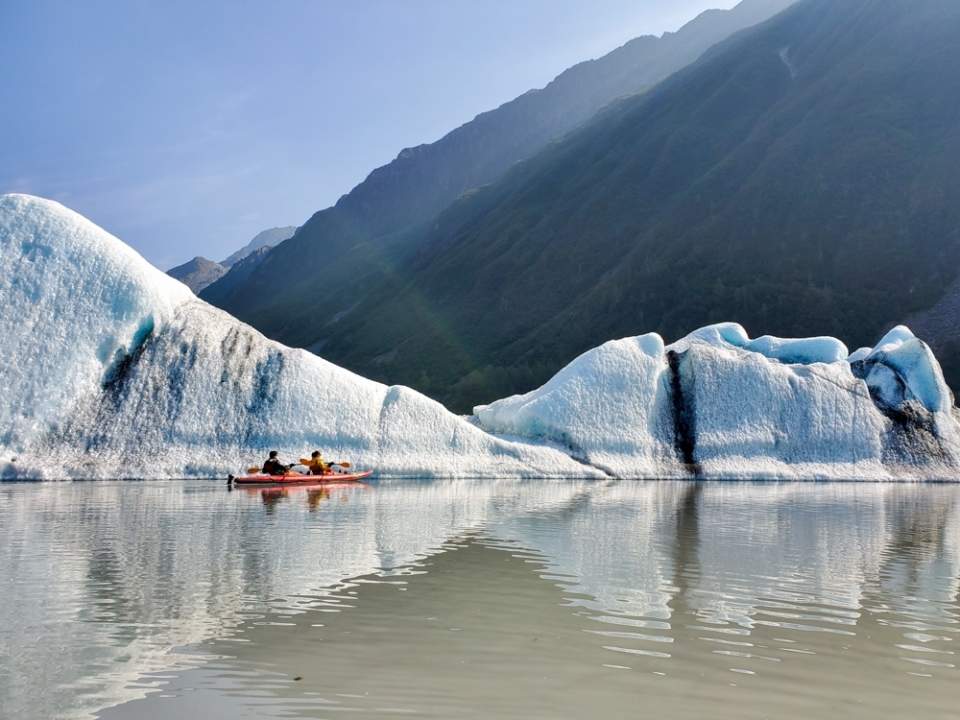 A kayaker paddles in Valdez Glacier Lake