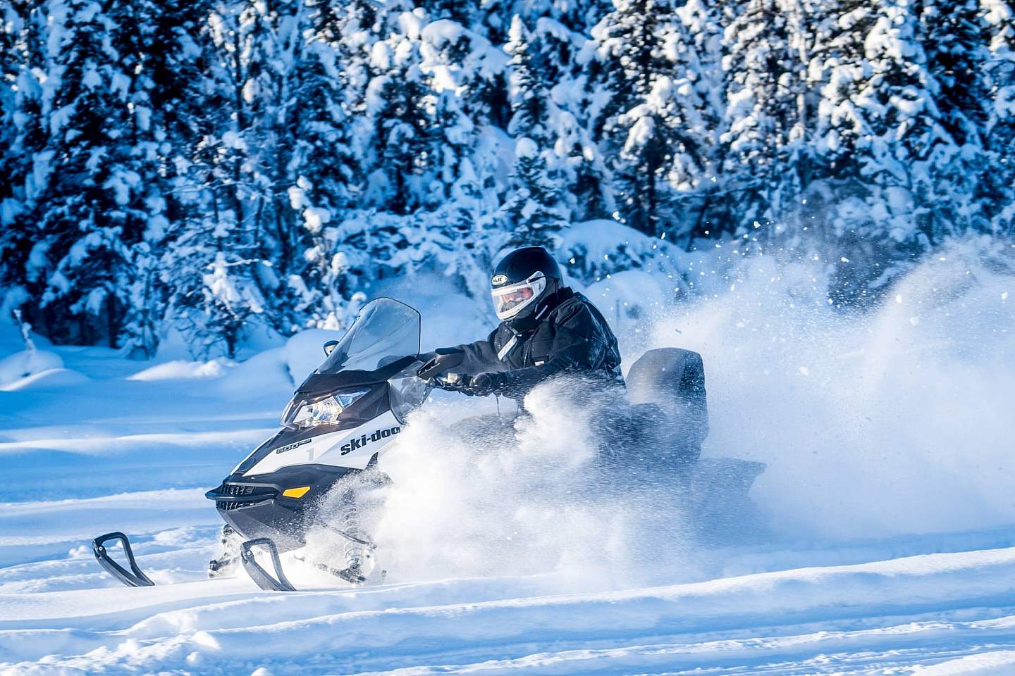 Someone on a snowmachining through the snow