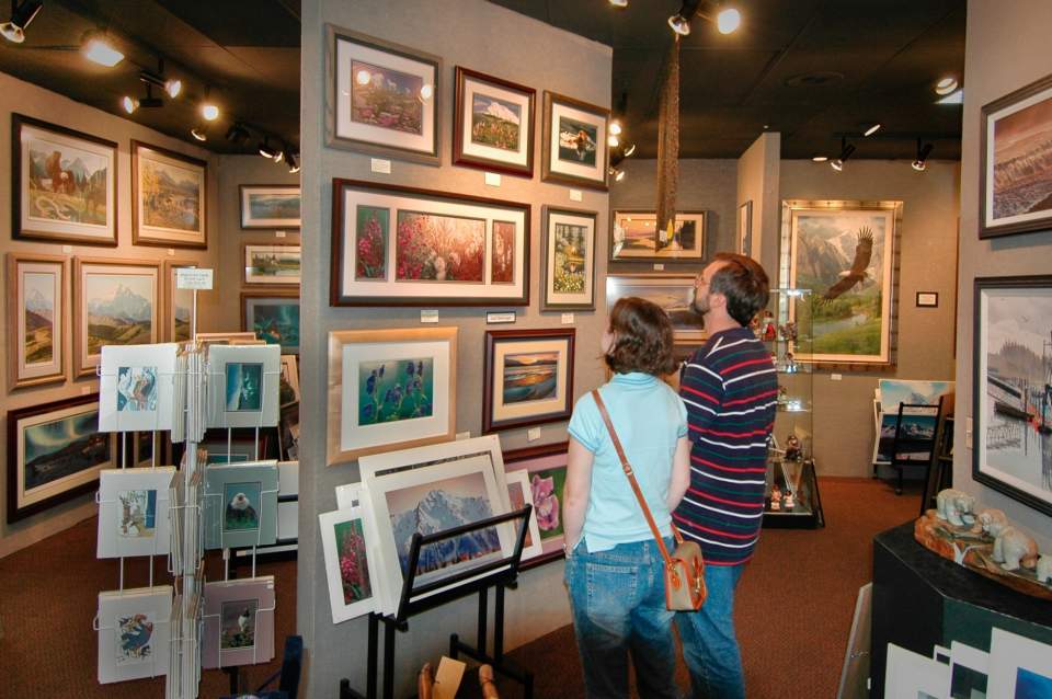 A couple look at art in a gallery.