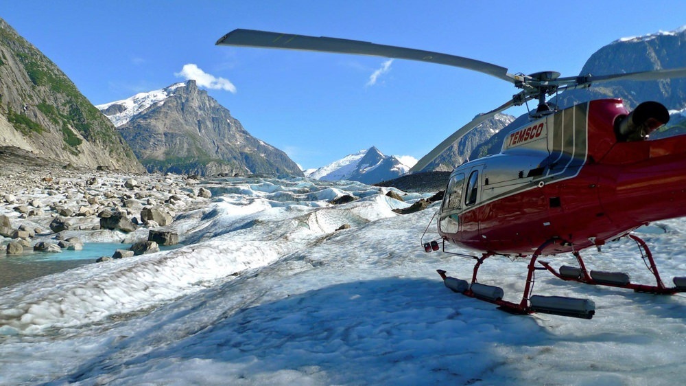 A helicopter landed on a glacier