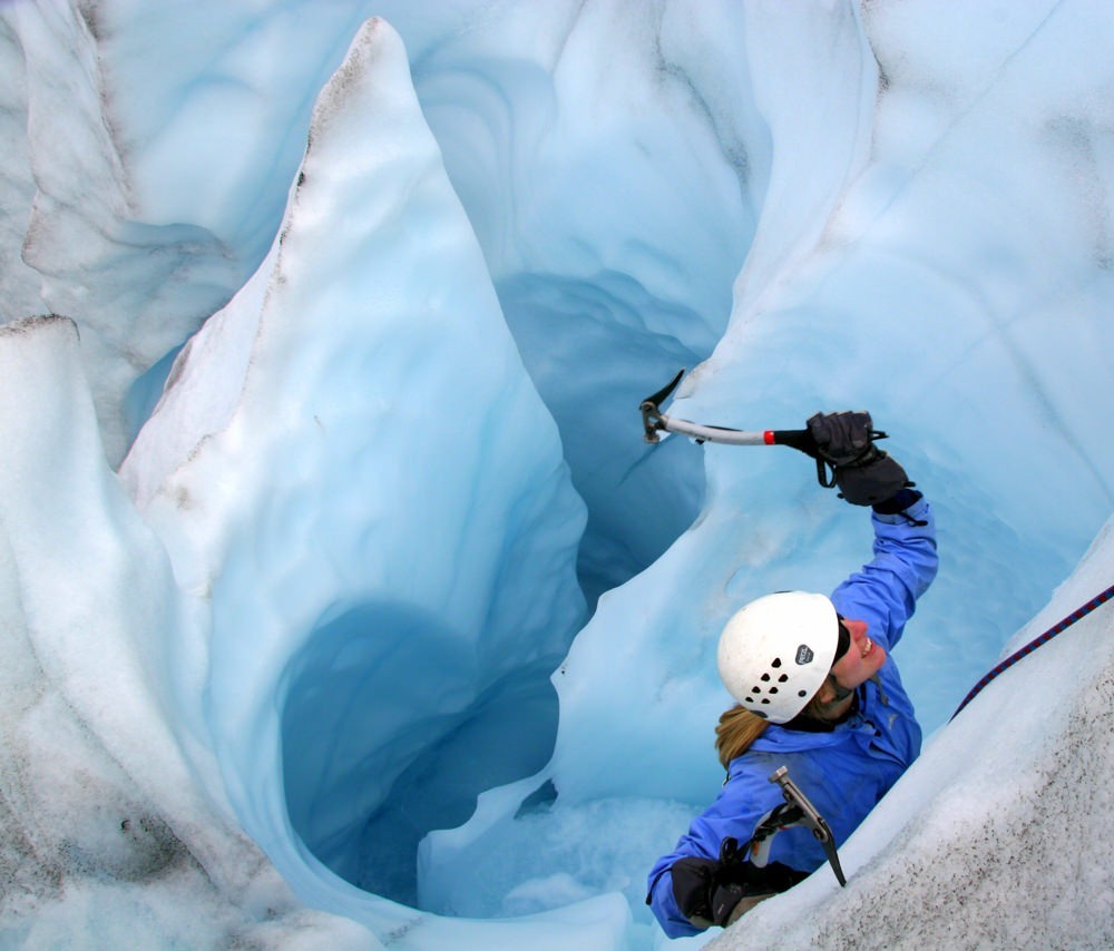 A person ice climbing on a glacier