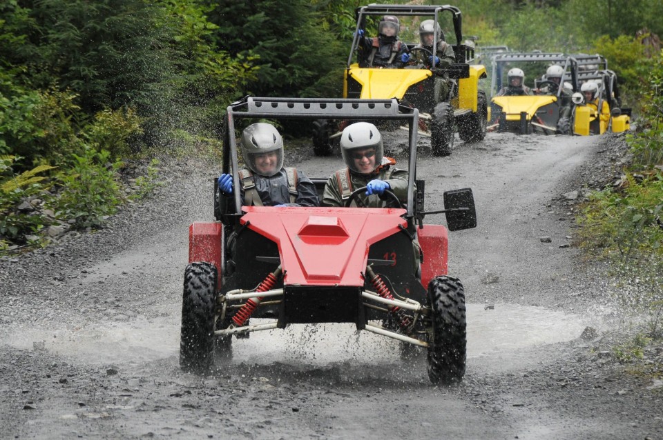 Guests splash through the mud on ATVs with Alaska Kart Expedition