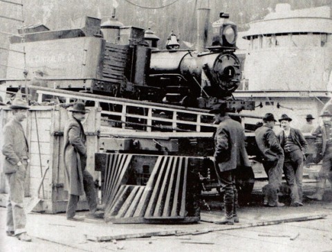 Old photo of a few men standing by an Alaska Railroad train