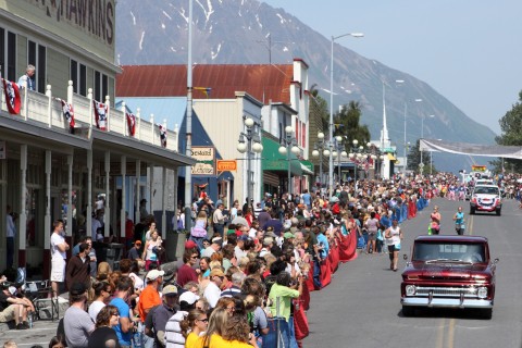 People lining the street for a 4th of July parade in Seward