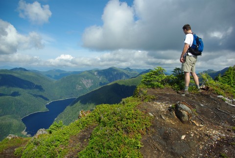 A hiker soaks in the scenery atop Deer Mountain.
