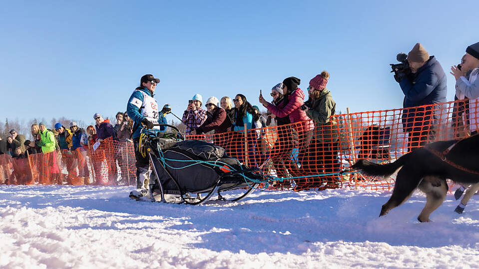 Fans cheer for an Iditarod Musher at the official start in Willow, Alaska