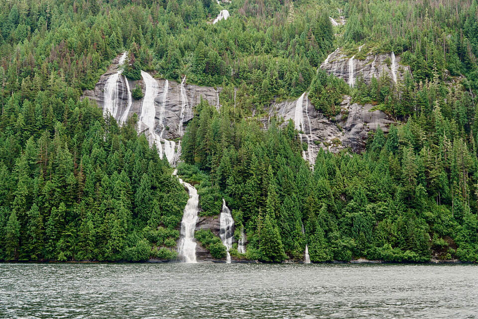 Waterfalls gush through thick rainforest in Misty Fjords National Monument