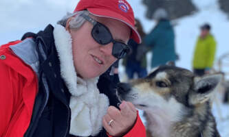 Guest with sled dog Dawn Campbell Glacier Dog Sleddingalaska org alaska helicopter glacier dog sledding