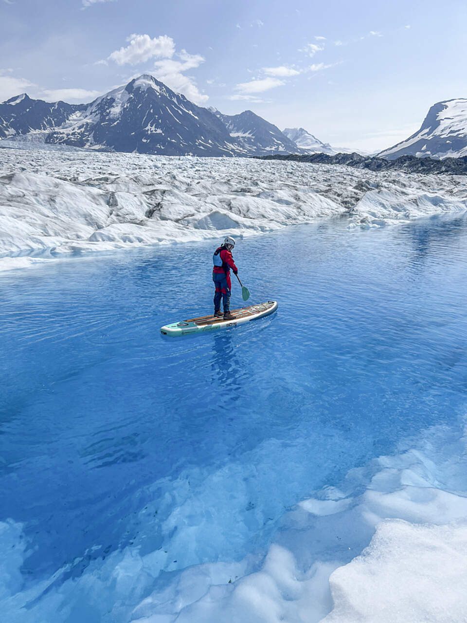 Experience paddleboarding in water as clear as the skies with Alaska Helicopter Tours