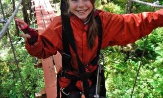 Alaska alpine zipline adventures juneau Alpine Zip JNU Girl crossing Bridge juneau