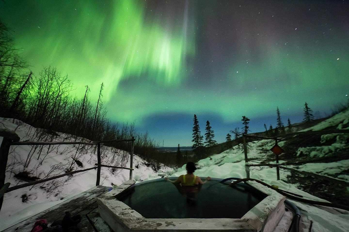 Soak in the hot springs of Fairbanks beneath the northern lights