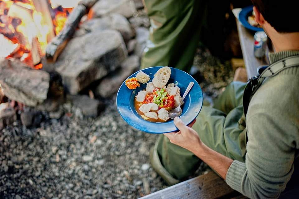 Your catch becomes the fresh center of a gourmet campsite meal.