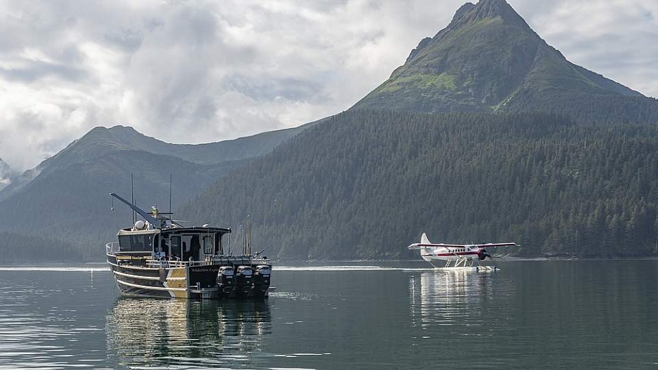 Floatplane lands near fishing boat in Kachamak Bay near Homer, Alaska