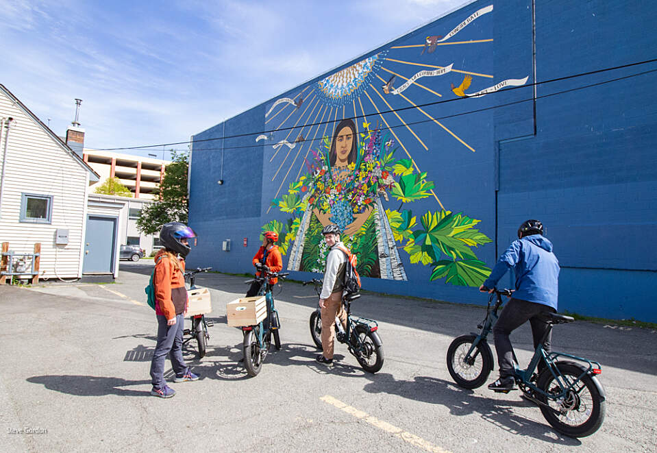 Pedal through Anchorage's vibrant streets and discover hidden murals with Freewheel Tours. Mural by Steve Gordon