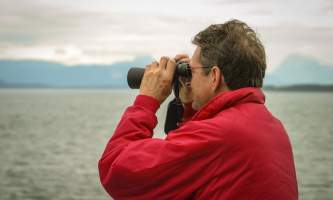 Glacier bay lodge GB tour man binolulars3 Alaska Channel