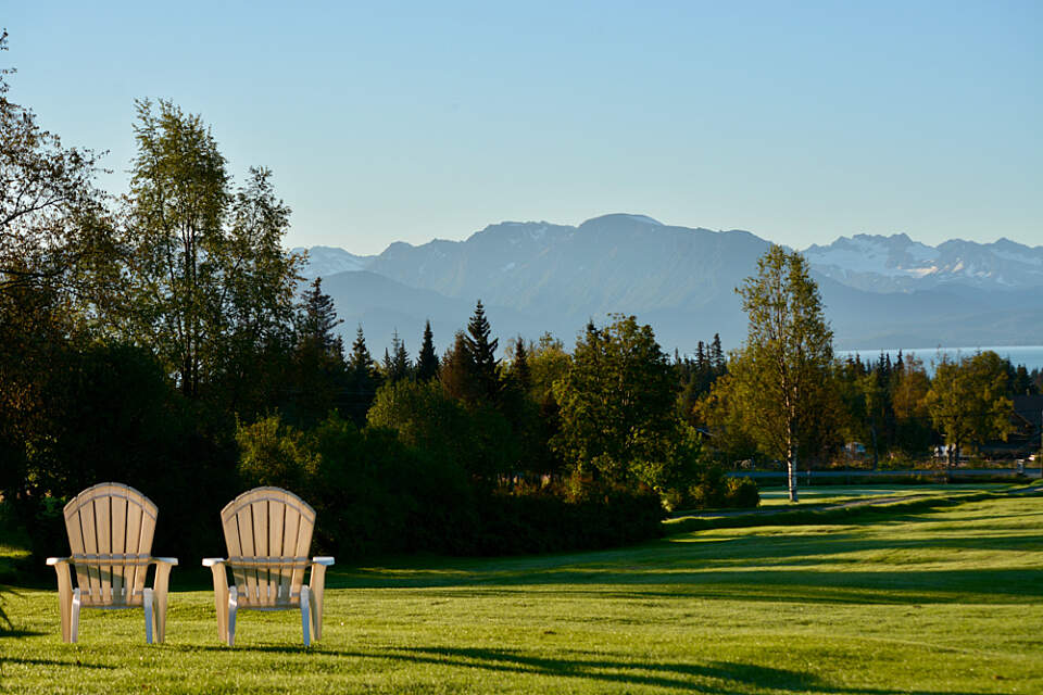 view of Kachemak Bay and adirondack chairs at Homer Golf Course