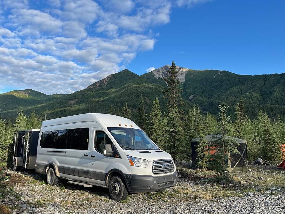 infinite adventures van parked in a camping area