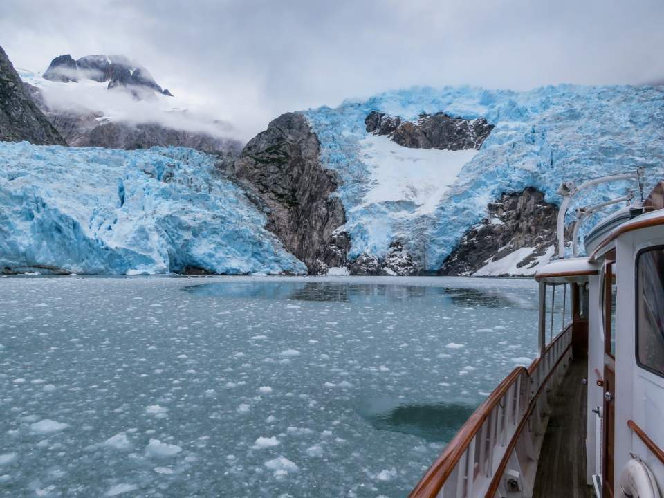 Look out from a boat at a glacier.