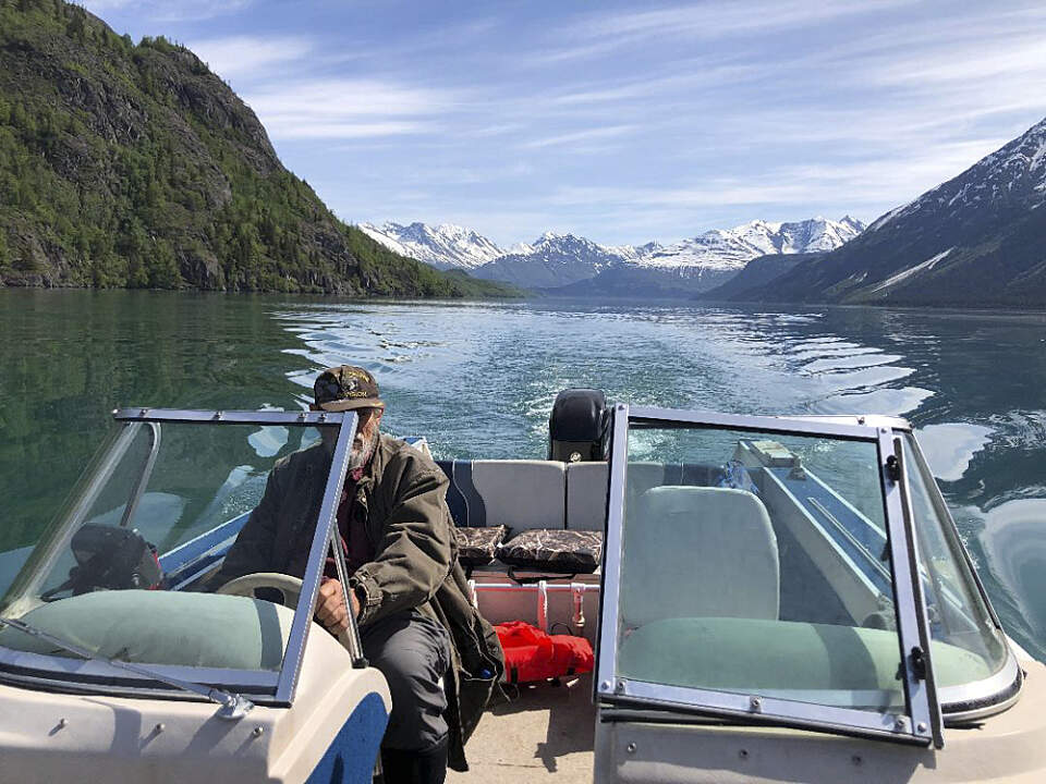 Prospector John captains the boat across Kenai Lake near Cooper Landing