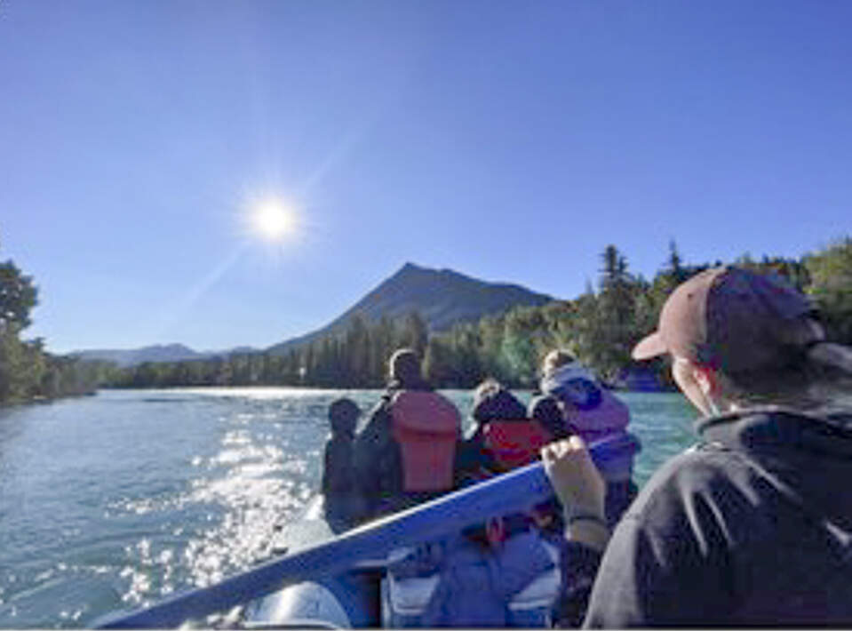 Guests float the Kenai River on the way to a remote mining camp