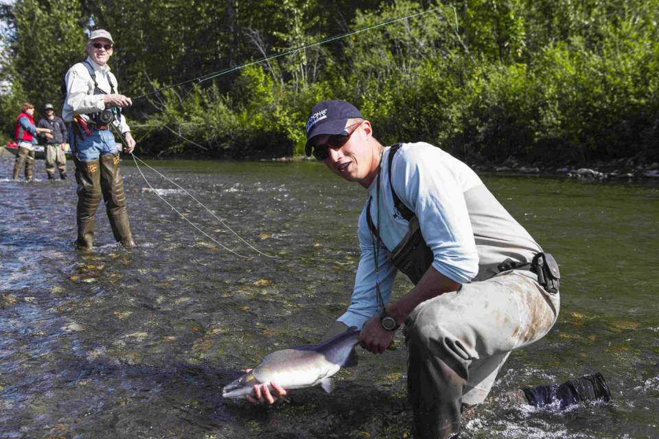 Man showing off his catch on a fly-in fishing trip with Rust's Air Service