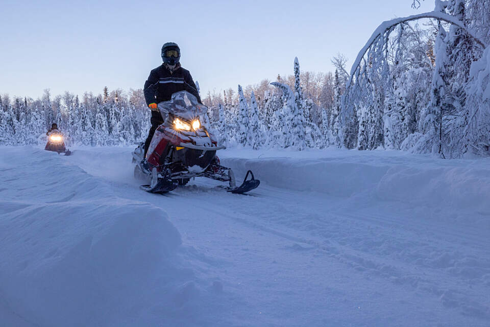 Combine dog sledding with a snowmobile adventure