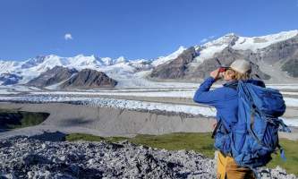Anya Voskresensky Backpacker takes a water break with incredible views of the Kennicott Glacier