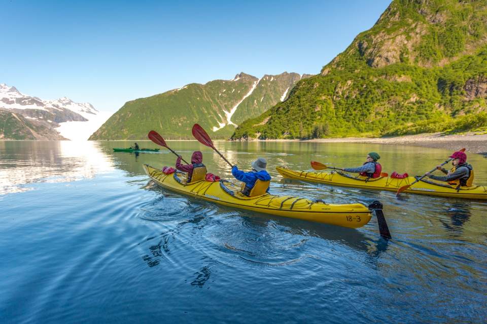 Kayakers paddle near Holgate Glacier in Kenai Fjords National Park