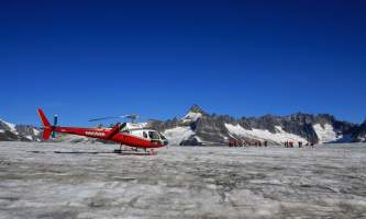 Temsco helicopter flightseeing Heli on Glacier Blue Sky Background
