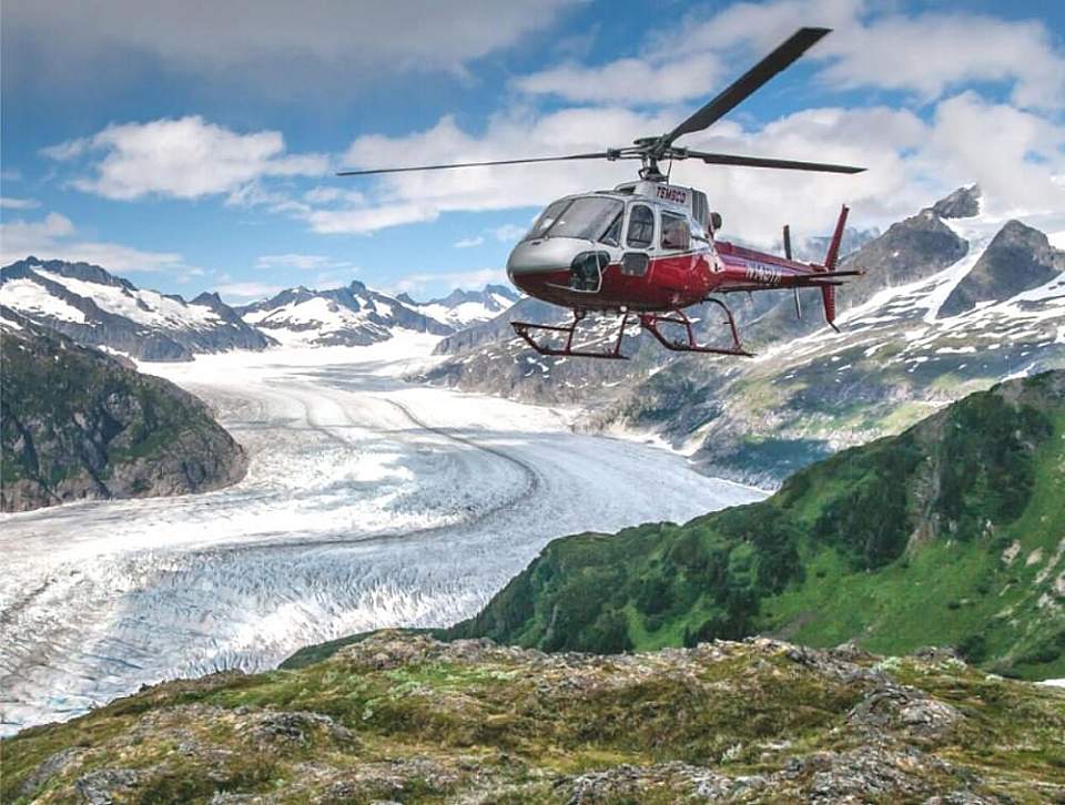 Helicopter flies over glacier in Juneau