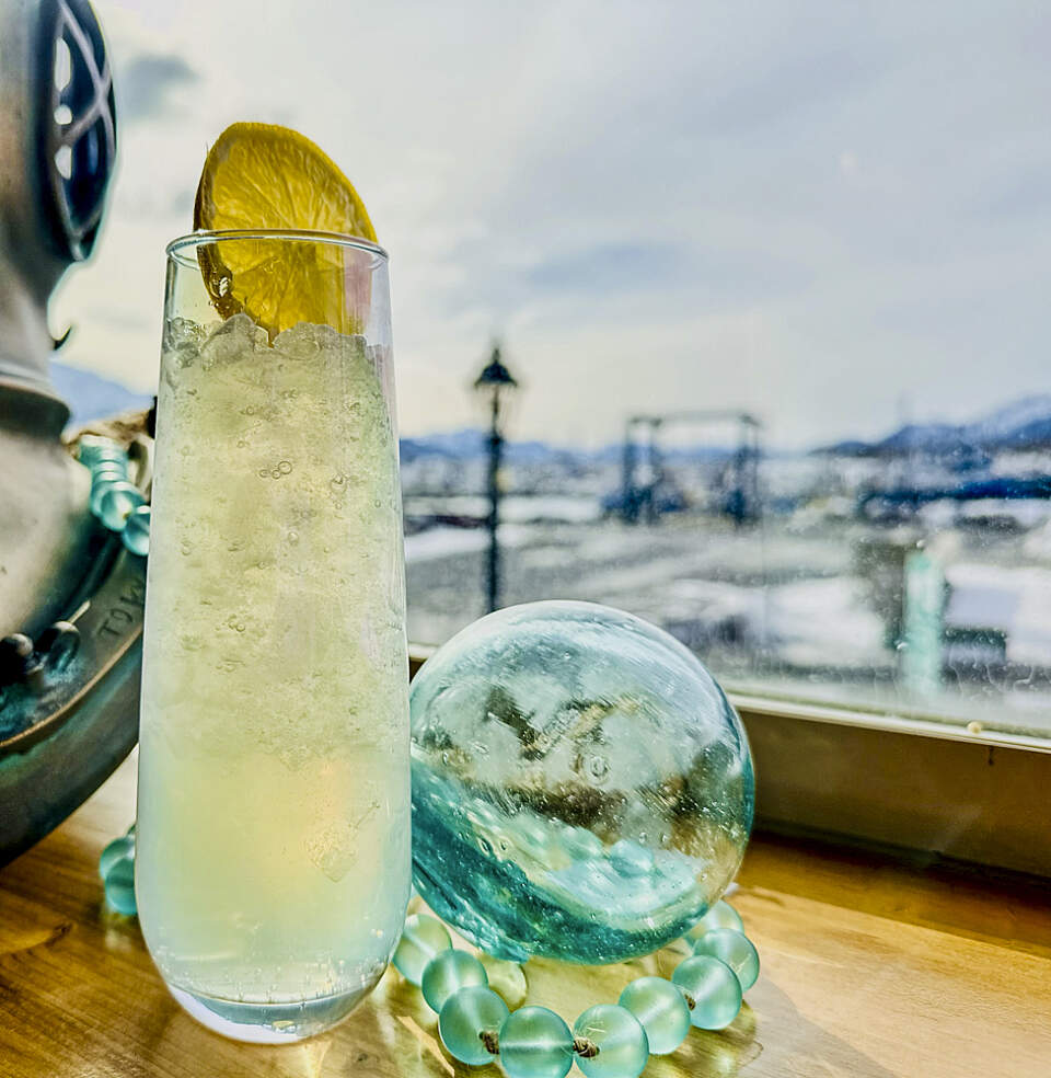 Cocktail with a few of the Seward waterfront and mountains at Tidewater Taphouse