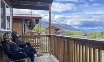 Alaska Glacier Lodge Ladies on cabin porch looking towards lodge Dawn Campbell