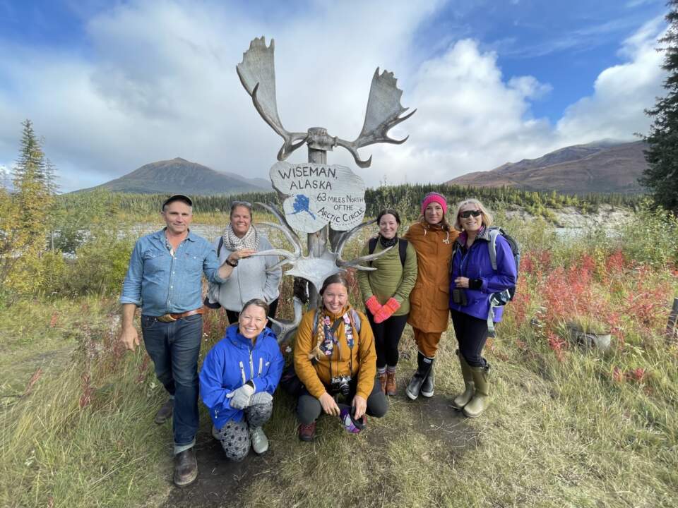 Group of guests at Arctic Hive stand by the Wiseman sign