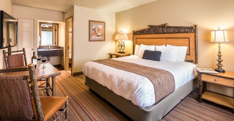 Inside of a bright and inviting guest room at Denali Princess Wilderness Lodge.