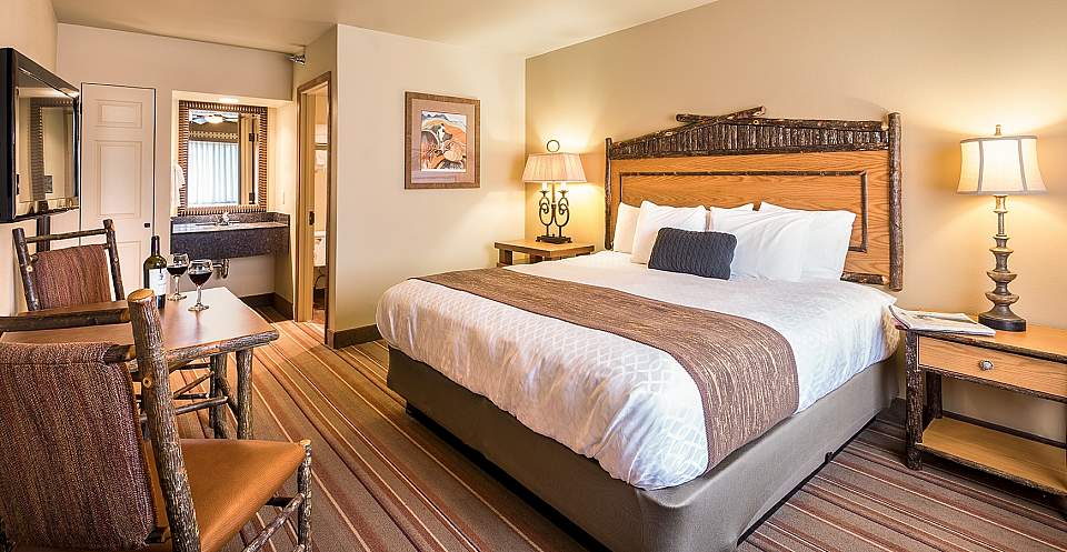 Inside of a bright and inviting guest room at Denali Princess Wilderness Lodge.