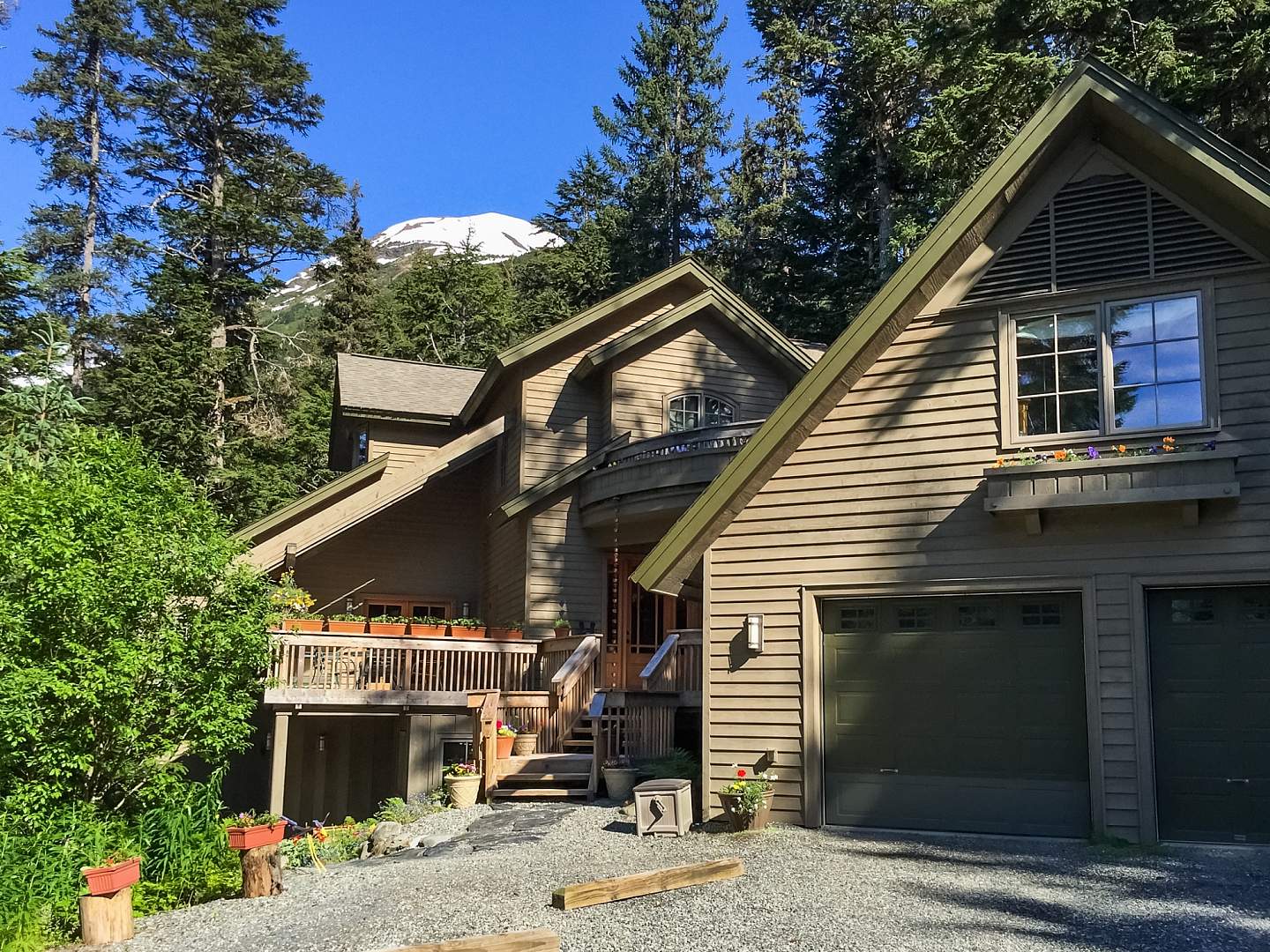 A large and cozy looking B&B nestled in a rainforest.