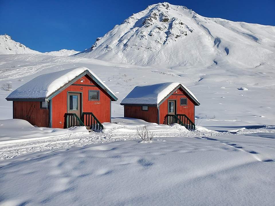 Snow covered cabins at Hatcher Pass Lodge in winter