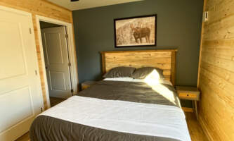 Moose Moose Bedroom w Bathroom Door Amy Jones2024alaska org kenai adventure cabin
