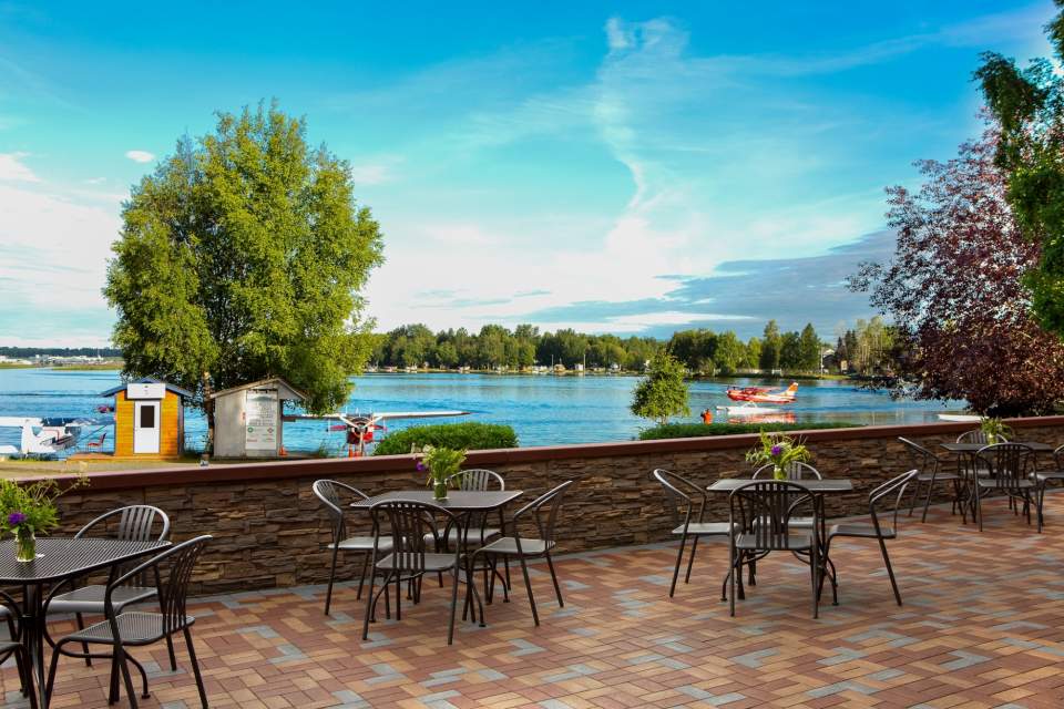 The outside dinning area of the Lakefront Anchorage with views of float planes on Lake Hood.