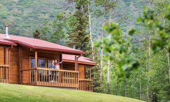Property Man and woman on cabin deck at Kenai kpl 19 alaska kenai princess wilderness lodge